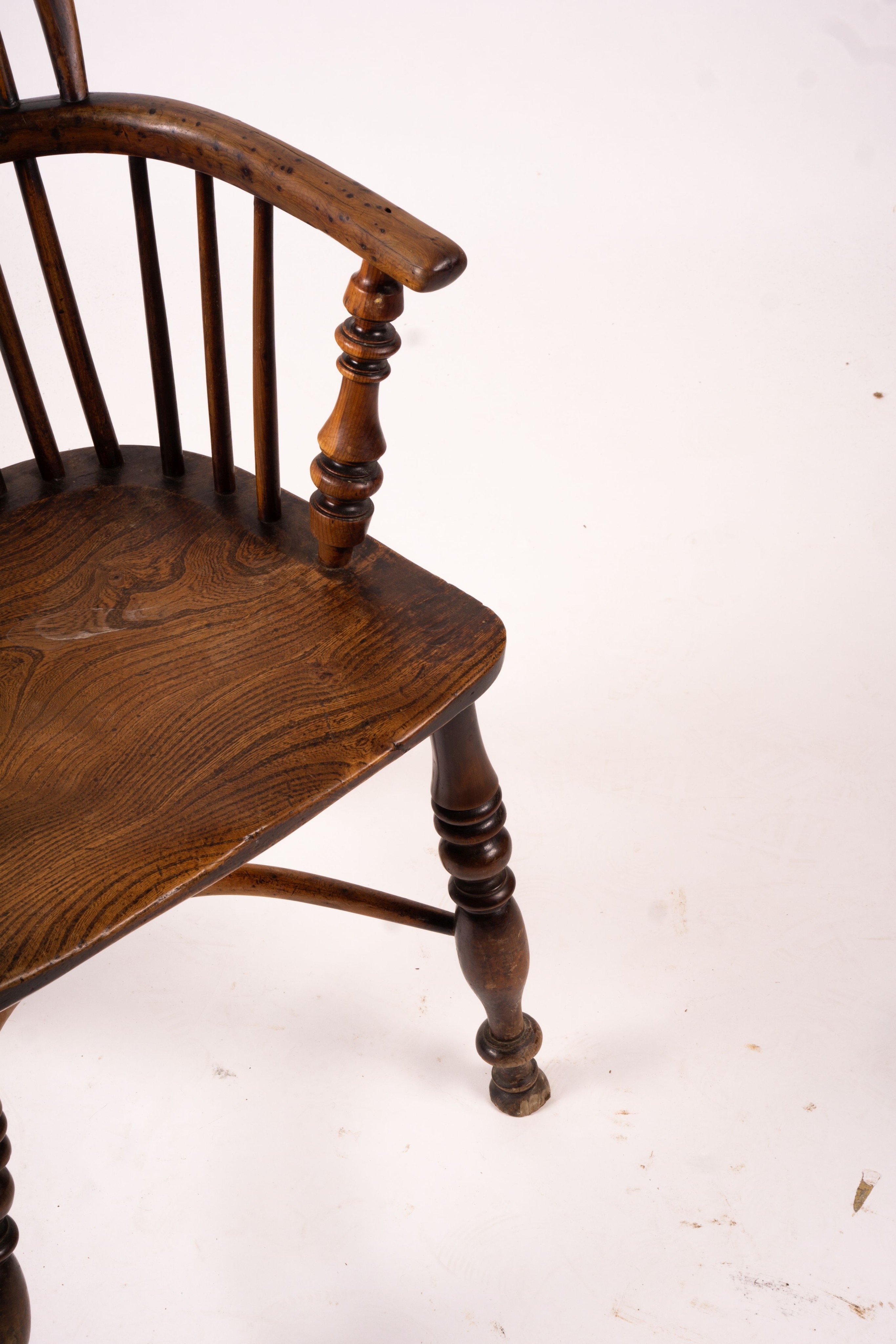 A mid 19th century yew and elm Windsor elbow chair with crinoline stretcher, width 54cm, depth 46cm, height 94cm